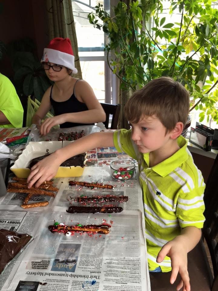 Child helping prepare food during family meal time