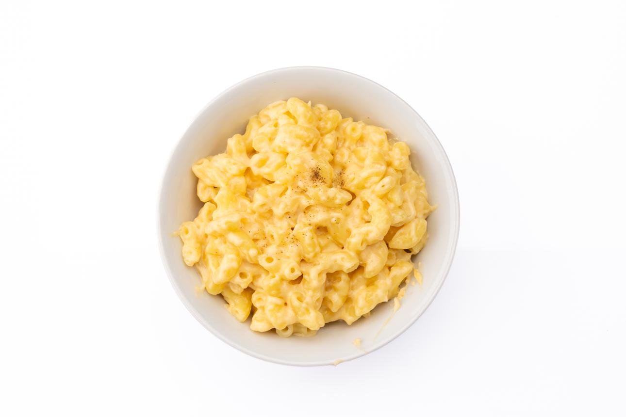 Creamy macaroni and cheese in a white bowl.